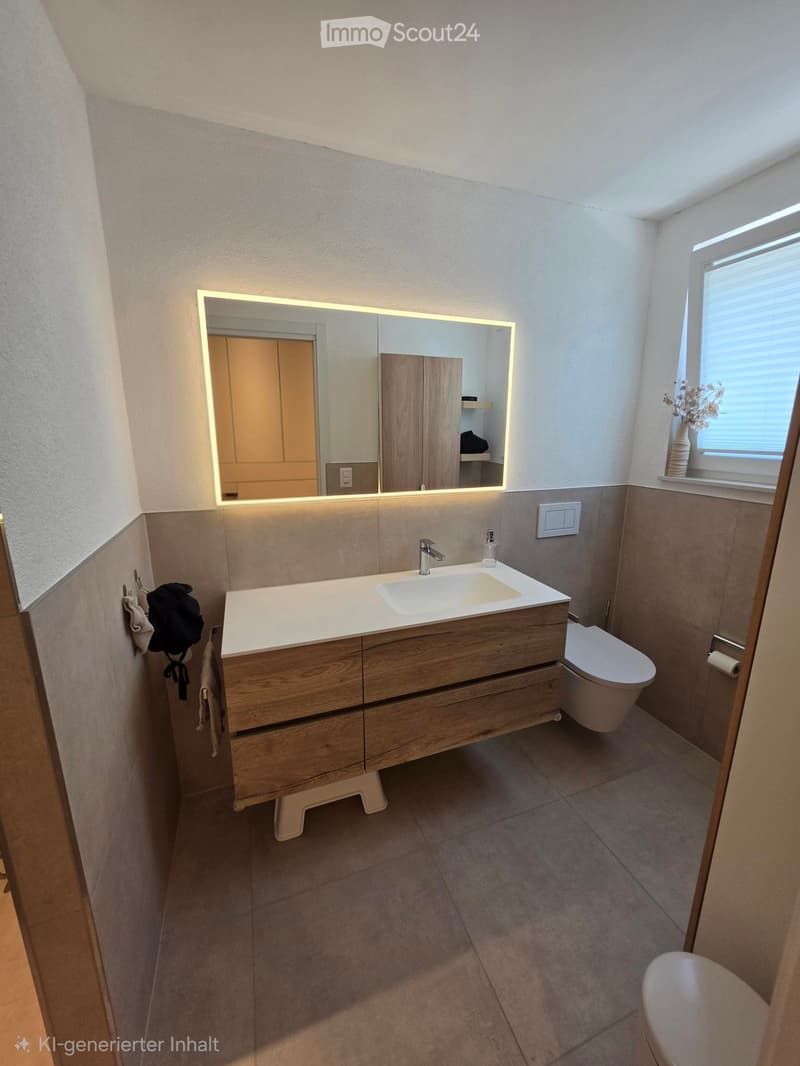 Modern bathroom with a wooden vanity, sink, mirror with LED lighting, toilet, and a window with blinds. A towel is hanging on the wall.