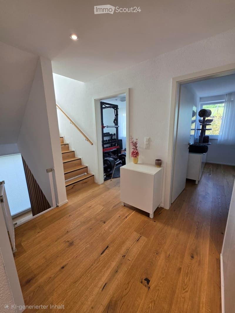 Bright hallway with wooden flooring, white walls, and recessed lighting. Features a small white side table with a vase and a candle, a staircase leading upwards, and open doors to adjacent rooms including a gym and a room with a cat tree.