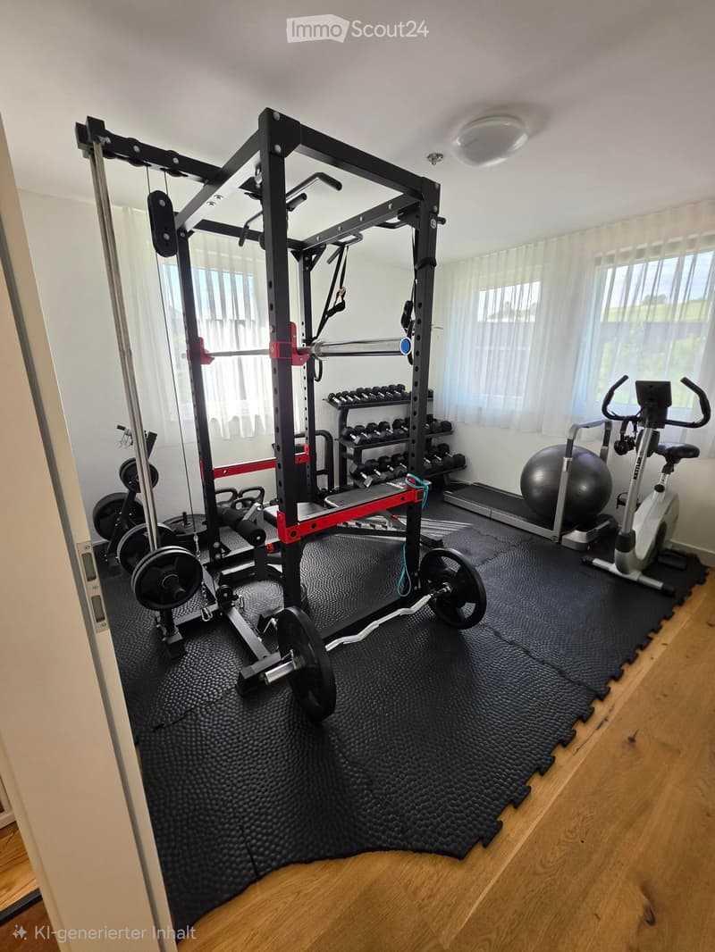 Well-equipped home gym with weight rack, dumbbells, elliptical machine, and exercise ball on a rubber mat.