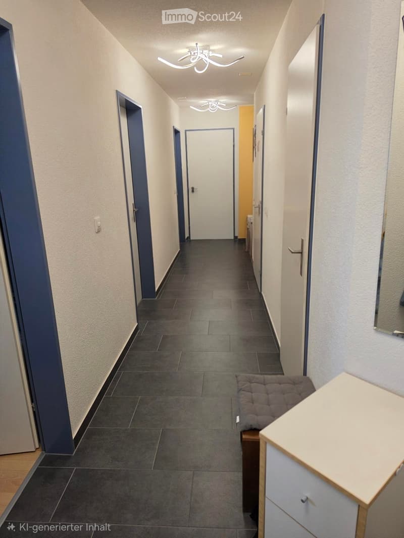 Clean hallway with dark tiled floor, white walls, multiple doors, modern lighting fixtures, and a small bench at the end.