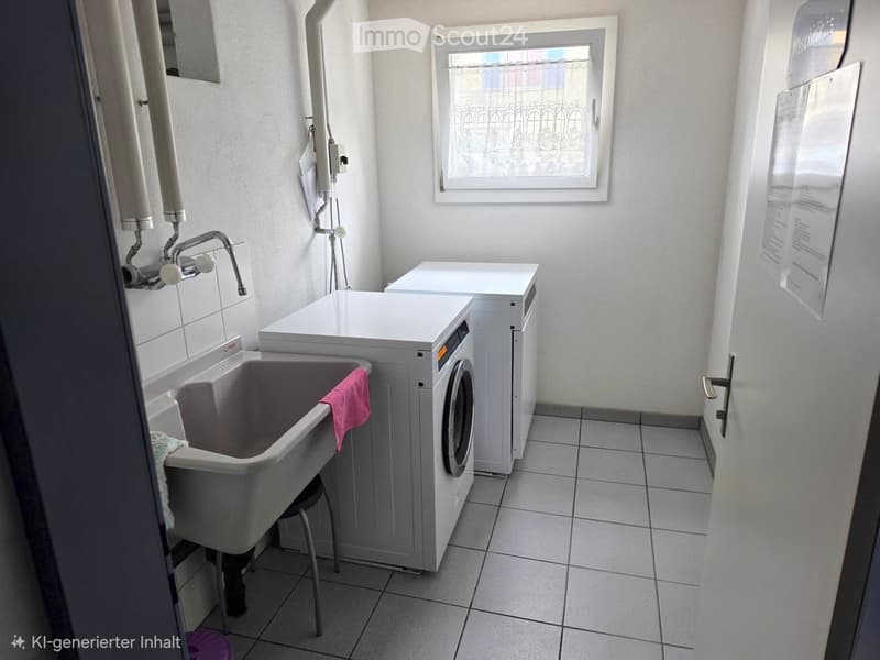 Bathroom with a sink, washing machine, and a small stool. The sink has a pink towel draped over it.