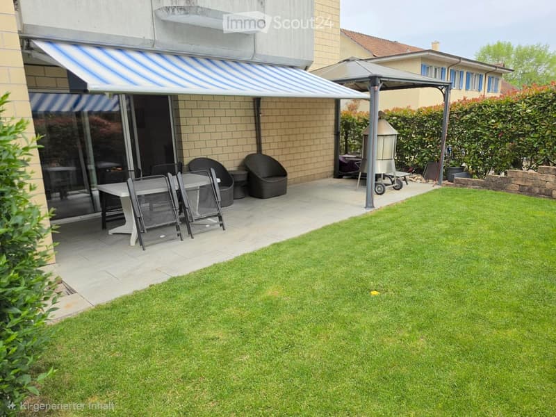 Well-maintained garden with a neatly trimmed lawn, patio area with a table, chairs, and an umbrella, along with a grill and additional seating.
