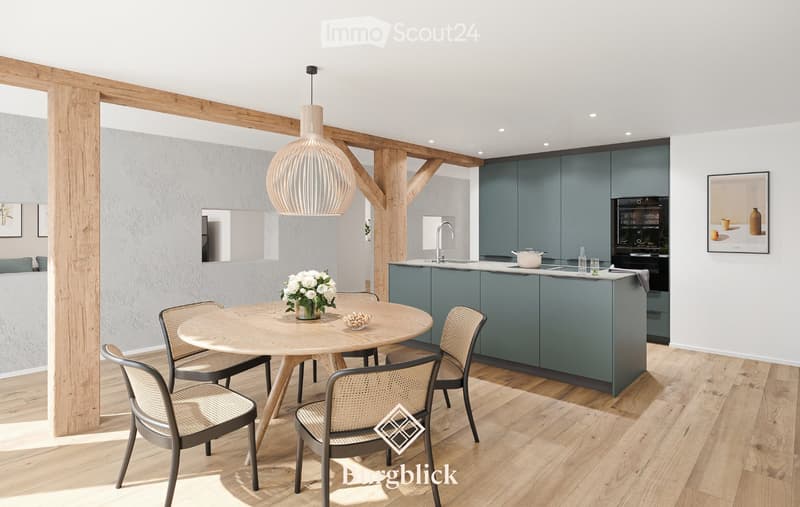 Modern kitchen with grey cabinets, wooden dining table, pendant light, and a vase of white flowers.