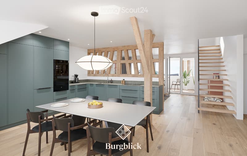 Modern kitchen and dining area with light wood flooring, grey cabinets, a white dining table with six chairs, and a pendant light hanging above the table. The kitchen features a sink, faucet, coffee maker, and oven.