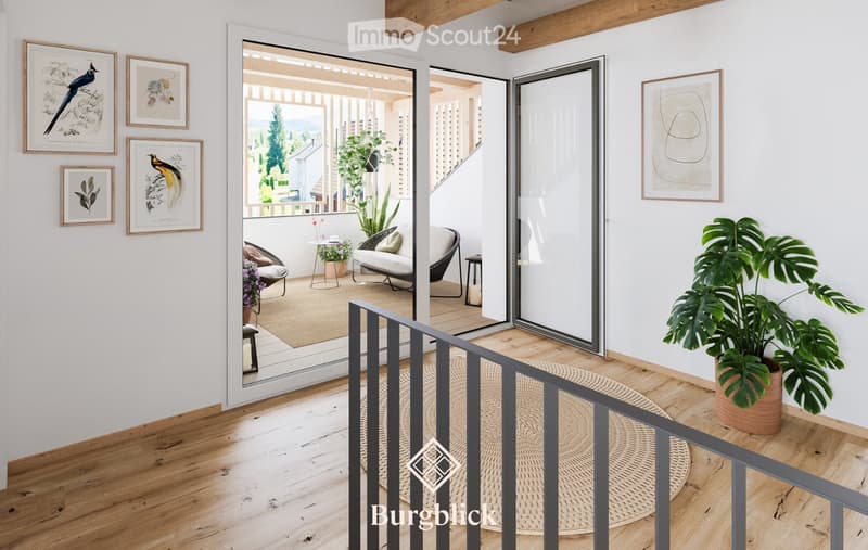 Modern living room with wooden floors, white walls, large glass doors leading to a balcony, several framed pictures, and potted plants.