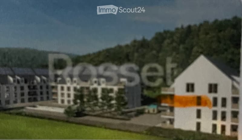 A model or rendering of a residential complex with multiple buildings, surrounded by greenery and hills in the background.