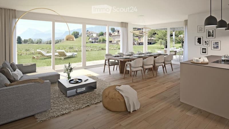 Open-plan living and dining area with wooden flooring, large windows overlooking a scenic landscape, a grey sofa, coffee table, dining table with chairs, and a kitchen island.