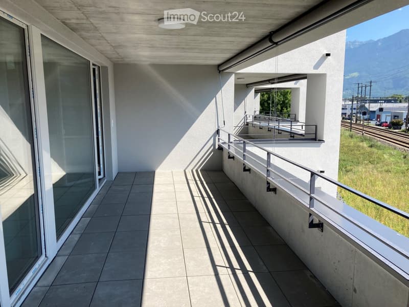 Balcony with tiled floor, glass doors, metal railings, and a ceiling light