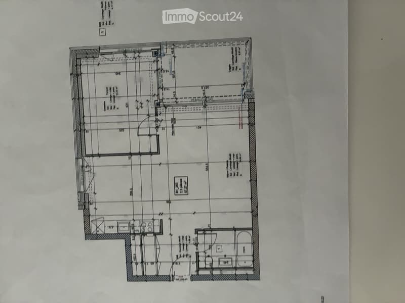 Floor plan of a residential building showing multiple rooms including living area, bedrooms, bathrooms, and kitchen.