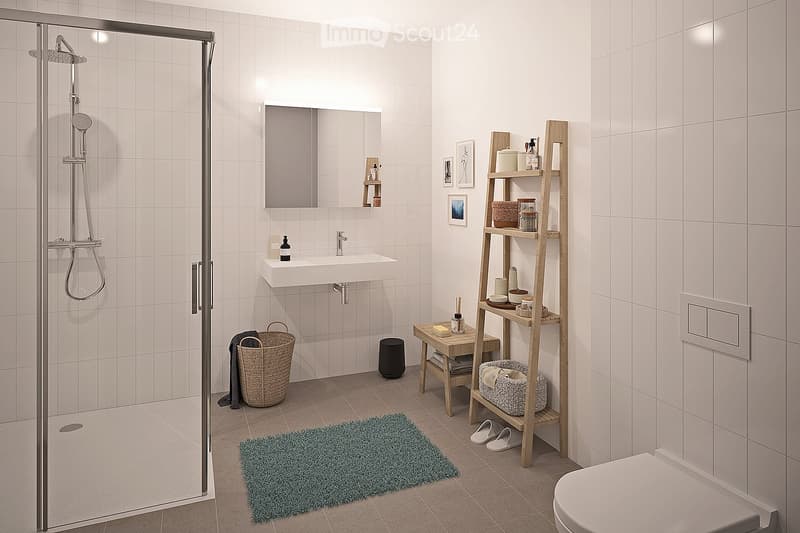 Modern bathroom with white tiles, a glass-enclosed shower, a white sink with a mirror, a wooden shelf, a small stool, a woven basket, a green rug, and a toilet.