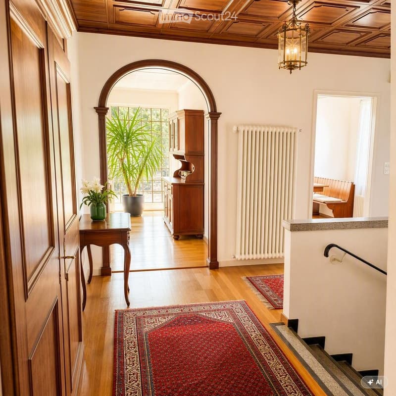 Elegant hallway with wooden floors, ornate wooden ceiling, arched doorway leading to a bright room, small wooden table with vase, wooden cabinet, radiator, and patterned rugs.