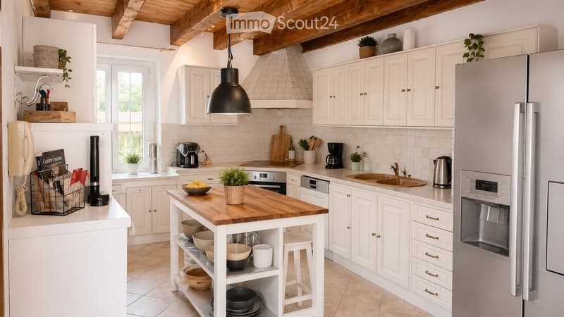 Bright, airy kitchen with white cabinets, wooden island, stainless steel appliances, and a hanging pendant light. Features include a sink, coffee maker, and various decorative items.
