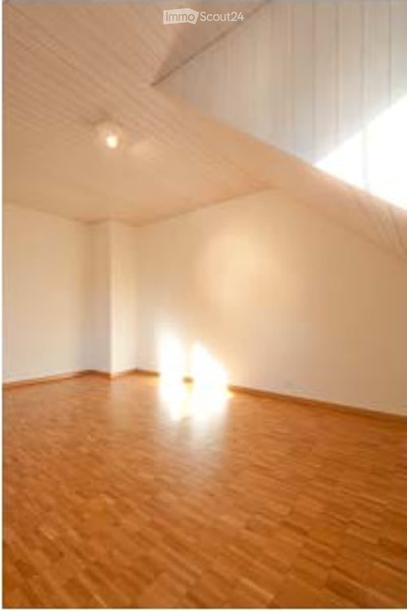 Completely empty room with wooden flooring and white walls. No furniture or equipment.