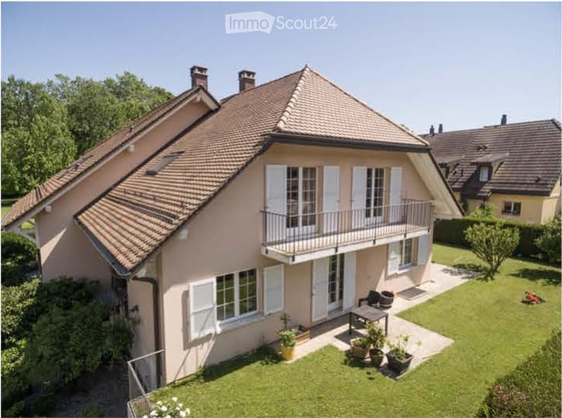 Single-story house with beige exterior, white shutters, and a balcony overlooking the front yard.