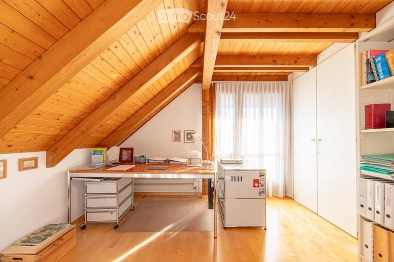 wooden ceiling, wooden floor, desk, lamp, shelves, books, picture frames, white curtains