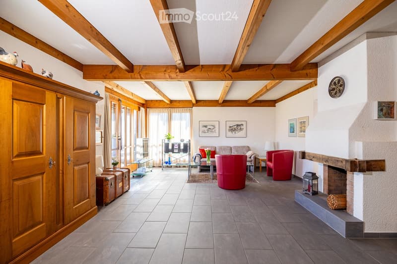 wooden beams, fireplace, red chairs, glass table, wooden cabinet, tiled floor