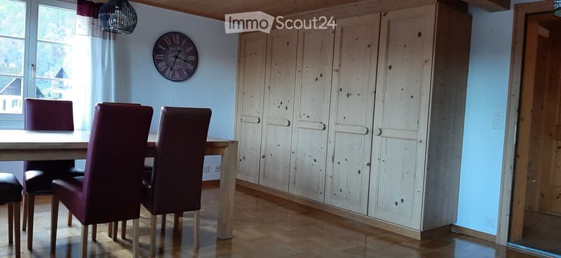 dining room, wooden table, 6 chairs, large cabinet, clock on wall, windows with curtains