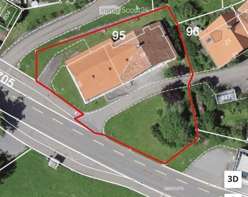 Aerial view of a residential building with a red-tiled roof, surrounded by green spaces and marked with property numbers.