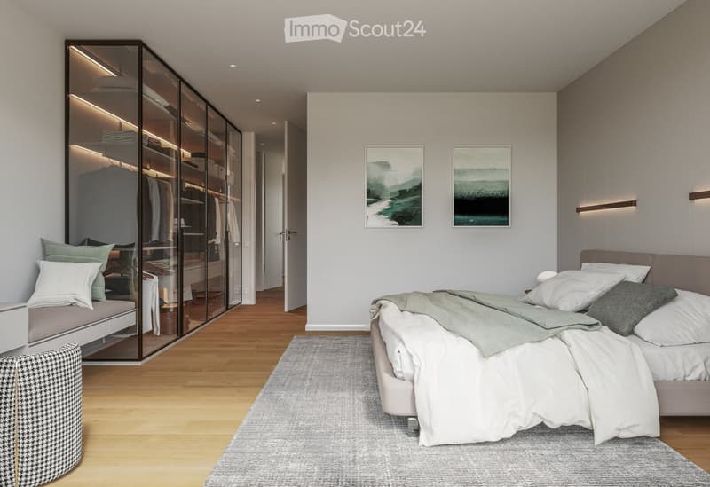 Modern bedroom with a large bed, bench seating, glass wardrobe, and artwork on the walls.