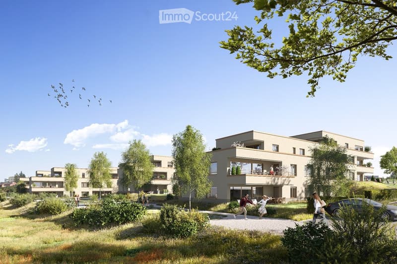 Modern residential complex with multiple buildings, balconies, greenery, and a parking area.