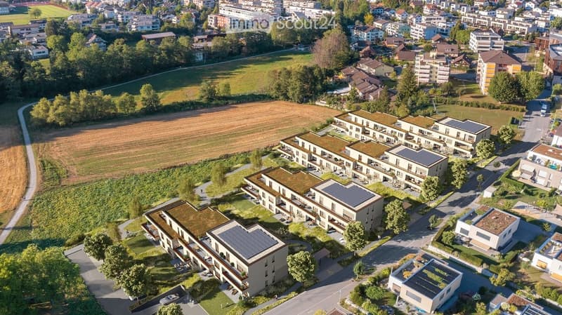 Aerial view of a residential area with multiple modern apartment buildings, green spaces, and surrounding neighborhood.