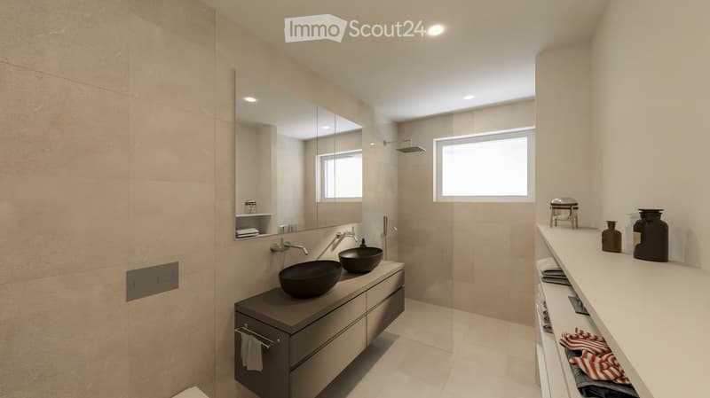 Modern bathroom with beige tiles, double sink vanity, large mirror, and a separate shower area with a glass enclosure.
