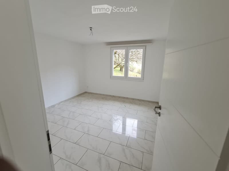 empty room, white walls, white tile flooring, window with view to outside
