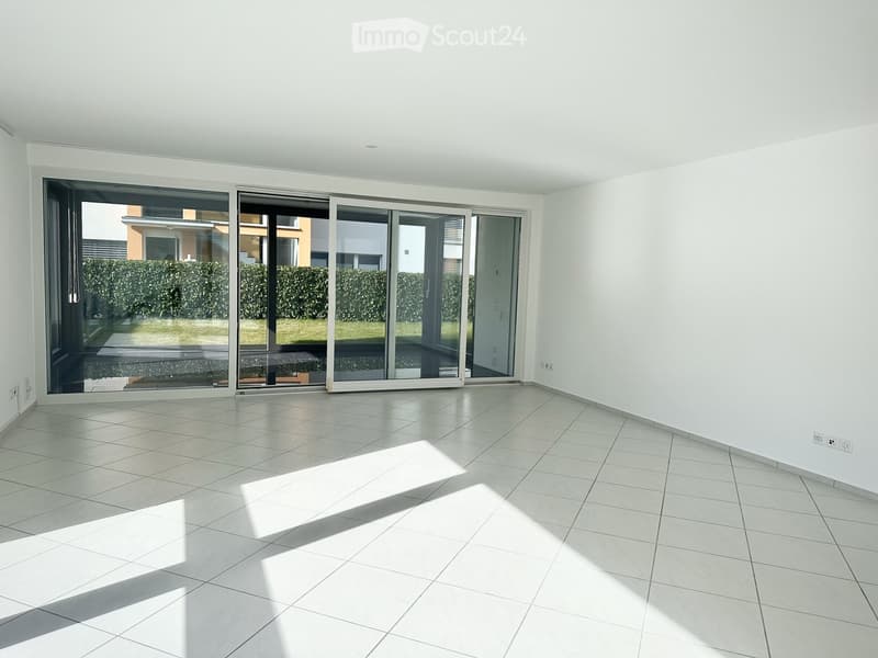 Empty room with glass sliding doors, tile flooring, white walls