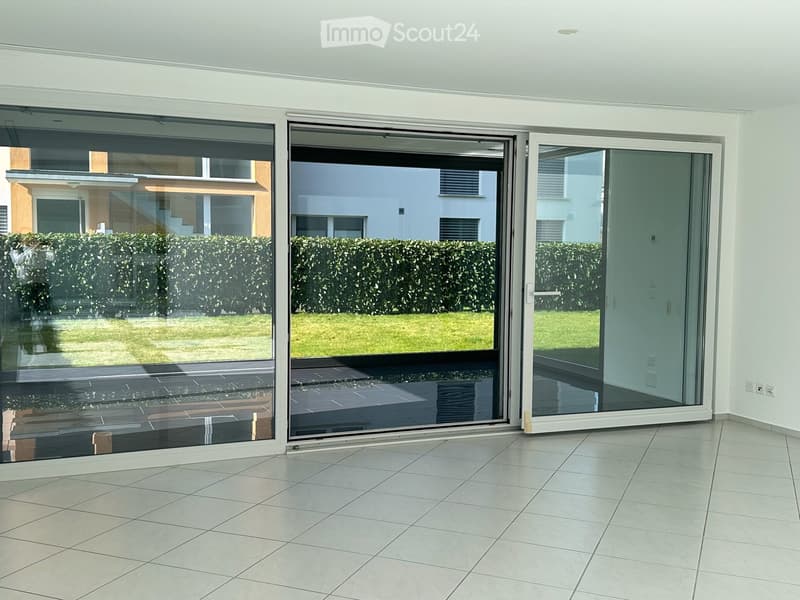 sliding glass doors, tile flooring, large glass windows, empty room
