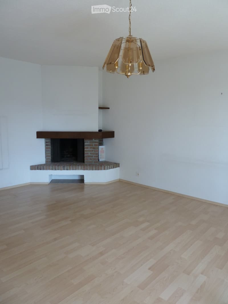empty room, fireplace, wooden floor, white walls, chandelier