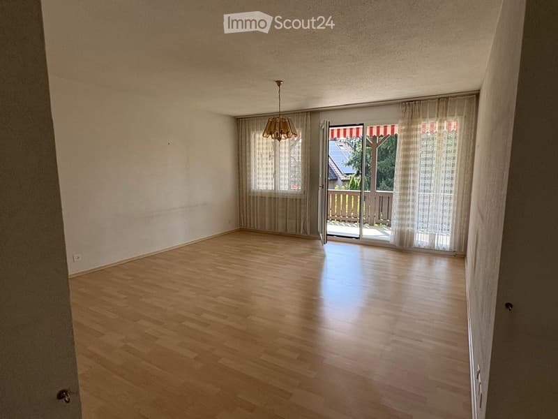 empty room, wooden floor, white walls, sliding glass doors, balcony, chandelier