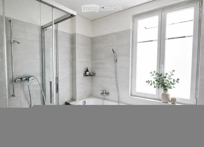 Modern bathroom with a bathtub, glass-enclosed shower, and a window with a small plant on the sill.