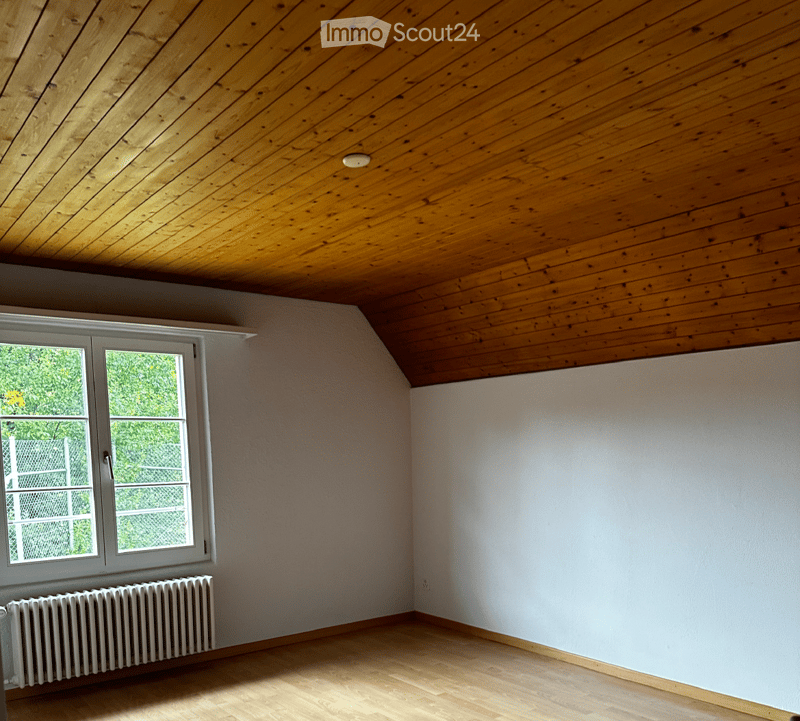 empty room, wooden ceiling, white walls, large window, white radiator