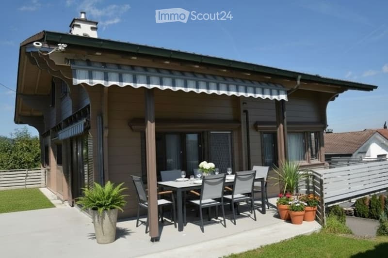 A modern house with a covered patio area featuring a dining set, potted plants, and a striped awning.