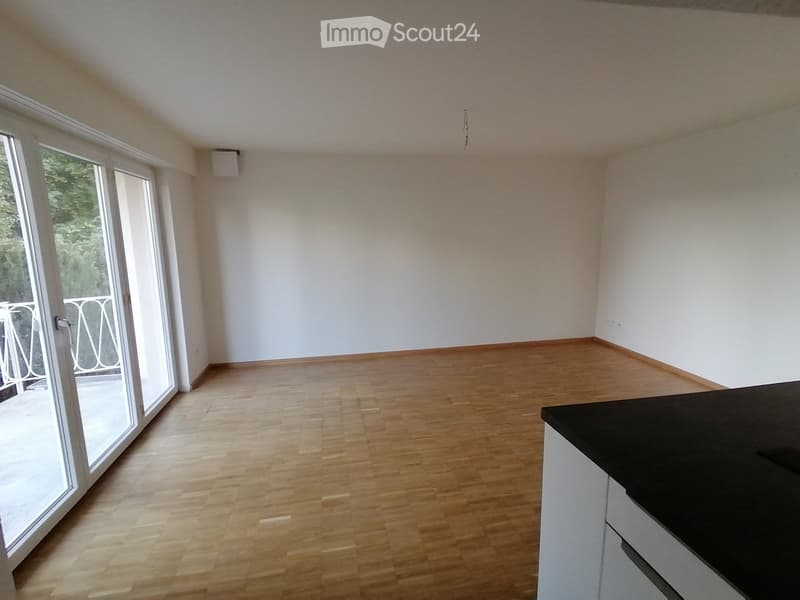 empty room, hardwood floor, sliding glass doors, balcony, white walls