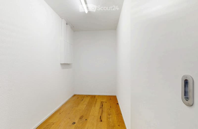Completely empty room with white walls and wooden floor. No furniture or equipment.