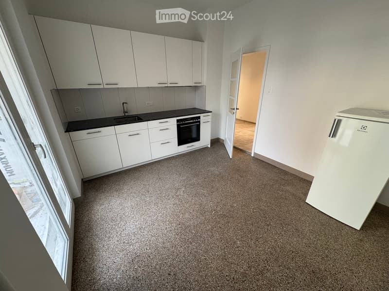 white cabinets, black countertop, sink with faucet, oven, dishwasher, washing machine