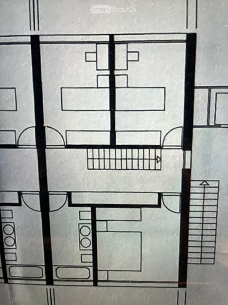 Floor plan of a multi-story building with several rooms, including bedrooms, bathrooms, and a living area.