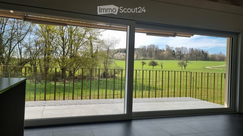 sliding glass doors, balcony, tiled floor, view of a green field