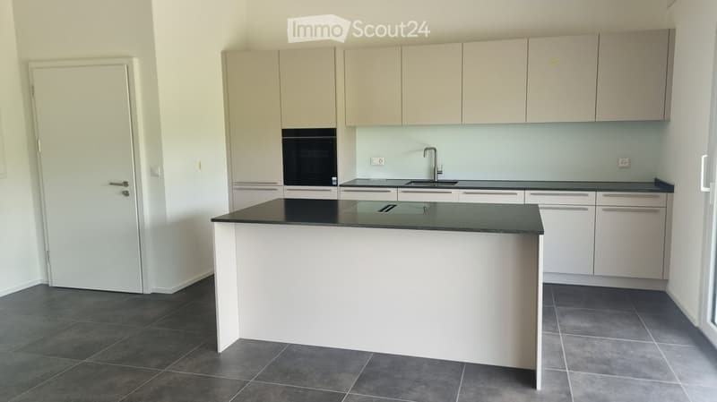 modern kitchen with white cabinets, black countertops, island, built-in oven, sink, faucet, dishwasher