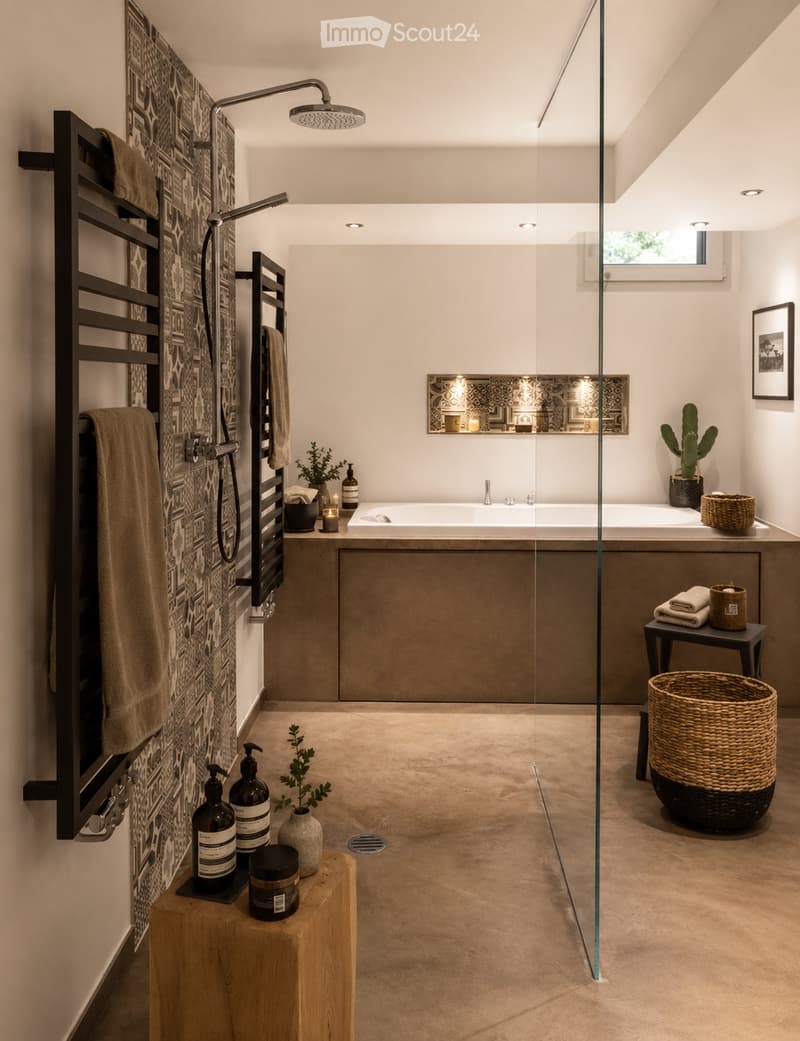 Modern bathroom with a freestanding bathtub, glass-enclosed shower, towel rack, small table with candles and bottles, and decorative plants.