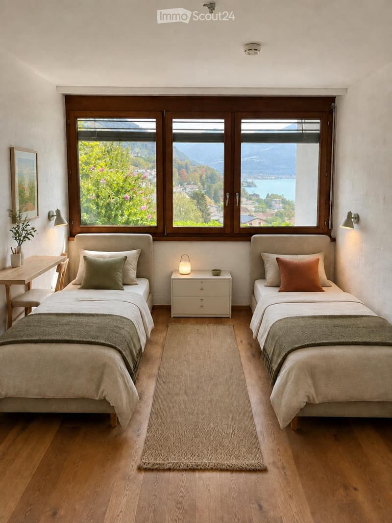Cozy twin-sized bedroom with two beds, nightstands, a small table, and a scenic mountain view through large windows.