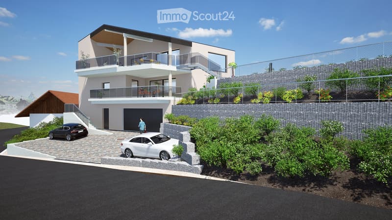 Modern two-story house with balconies, garage, and raised ground floor, surrounded by greenery and a parking area.