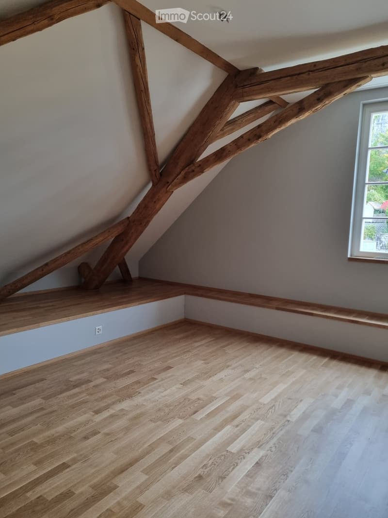 wooden beams, wooden floor, bench seating, window, power outlet
