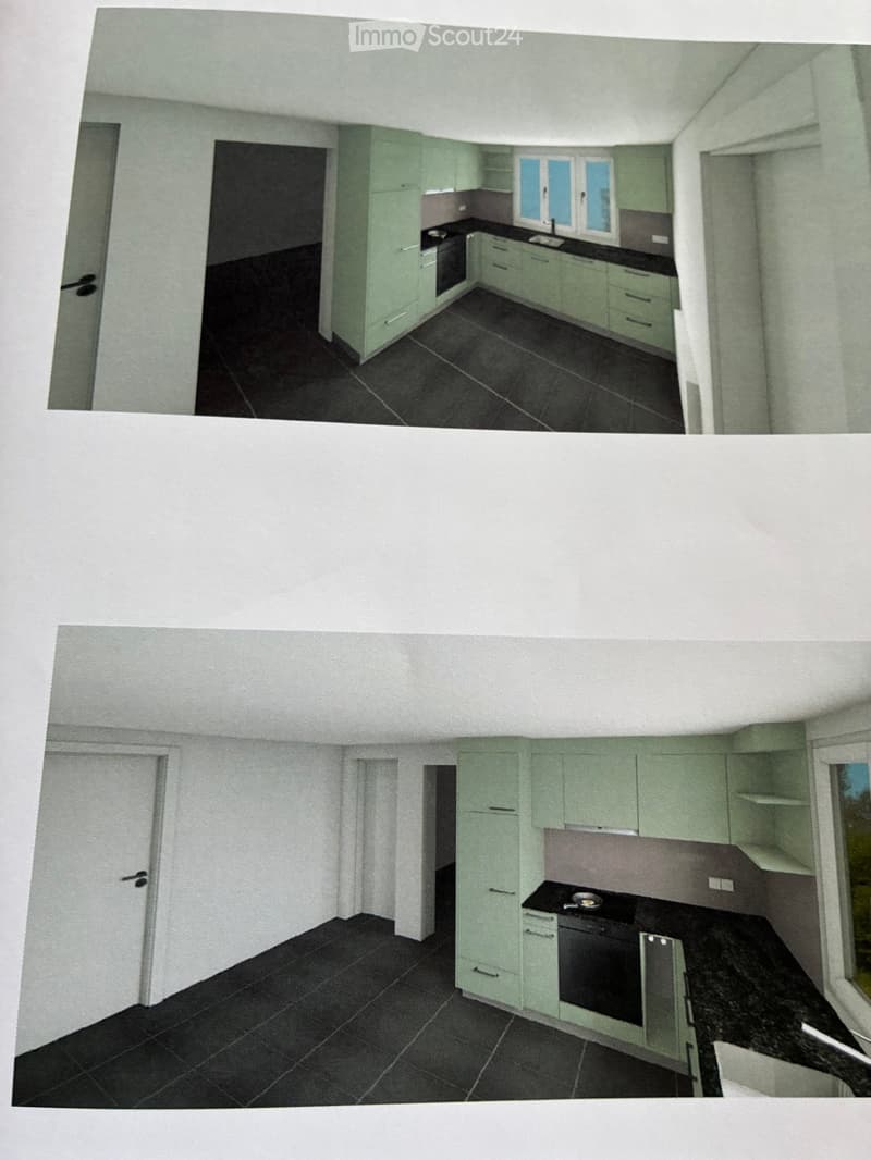 Modern kitchen with light green cabinets, black countertop, and black tiled floor. Features an oven and sink.