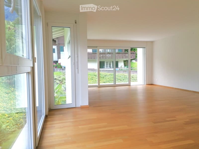wooden floor, large windows, balcony, sliding doors, no furniture