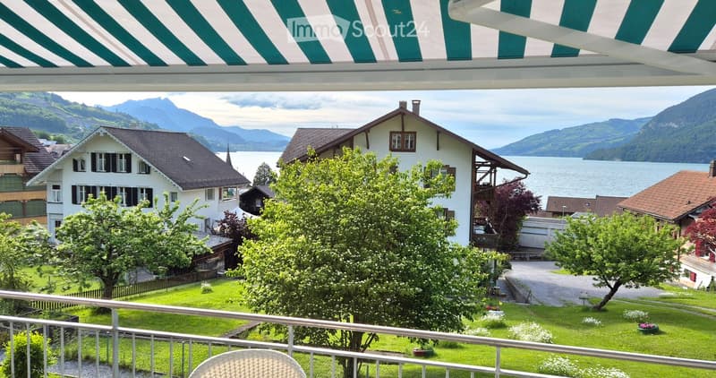 balcony, overlooking houses, trees, lake, mountains