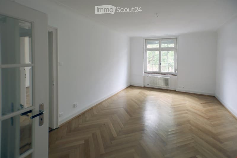 empty room, hardwood floor, white walls, white radiator, window, glass door, no furniture