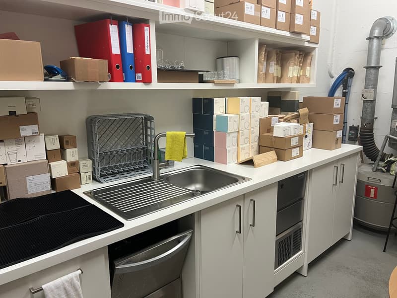 A kitchen with a sink, dishwasher, and cabinets