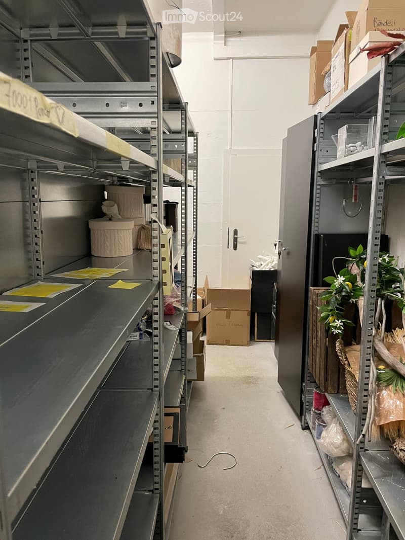 Storage room with metal shelves, boxes, and various items on the shelves